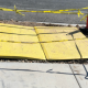 Pedestrian trench plates covering open utility trench.