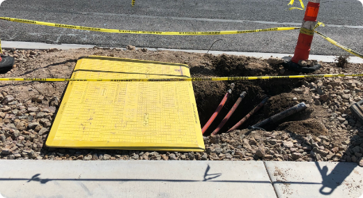 Pedestrian trench plate covering utility hole.