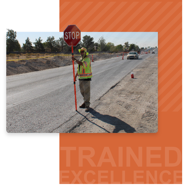 Traffic control flagman holding stop sign controlling traffic in work zone