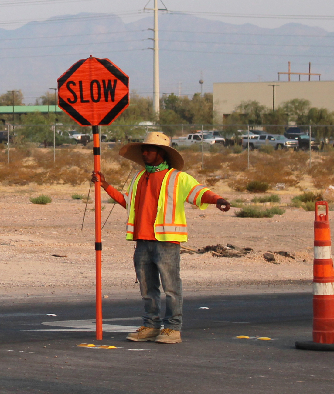 Traffic control flagman holding slow sign