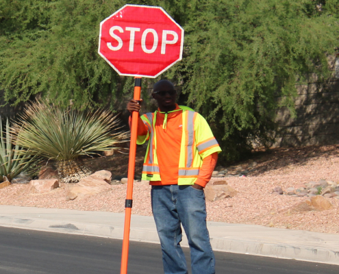 Traffic control flagman holding stop sign