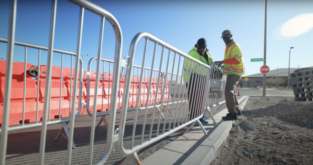 Two workers setting up pedestrian rails